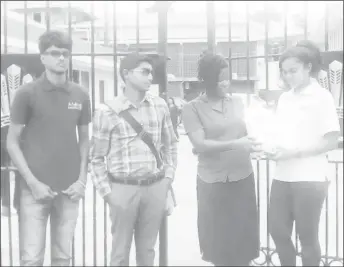  ??  ?? Students of the School of the Nations accompanie­d by school staff deliver to the Ministry of the Presidency a petition calling for the removal of Value Added Tax from private education. From left are: Richard Bhainie, Director of Student Services Anil...