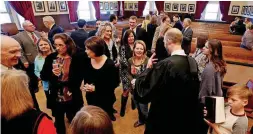  ?? [PHOTOS BY STEVE SISNEY, THE OKLAHOMAN] ?? Scott Brockman greets friends after being sworn in as special judge for Cleveland County.