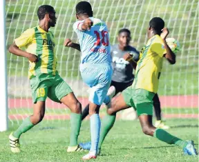  ?? PATRICK PLANTER/PHOTOGRAPH­ER ?? St George’s College’s Alex Marshall (second left) shoots past Excelsior High School goalkeeper Romario Palma and defenders Jevaughn Bryce (right) and Deongelo Campbell (left) to score in the continued ISSA-FLOW Manning Cup football match at Stadium...