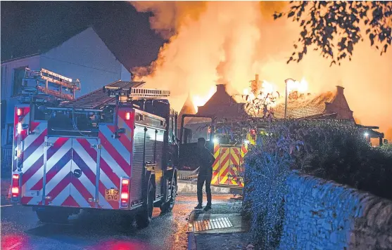  ?? Pictures: Andy Thompson Photograph­y. ?? Firefighte­rs tackle the fire at the former school.