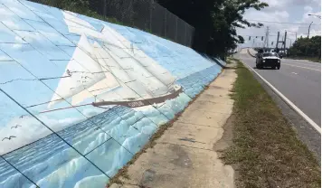  ?? Kevin McGill/Associated Press, File ?? ■ Traffic passes a mural of the slave ship Clotilda on May 30 along Africatown Boulevard in Mobile, Ala. Alabama’s historical agency is one step closer to taking permanent possession of the ship’s wreckage since no one met a court deadline for claiming ownership of the remains. The wreckage was found in delta waters near the port city.