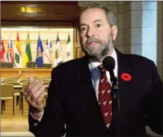  ?? CANADIAN PRESS PHOTO ?? With the doors to a caucus room wide open, NDP leader Tom Mulcair speaks with reporters on Parliament Hill Wednesday in Ottawa.