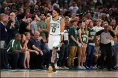  ?? Stacy Revere / Getty Images ?? Jayson Tatum of the Boston Celtics reacts to three of his game-high 46 points against the Milwaukee Bucks on Friday night at TD Garden.