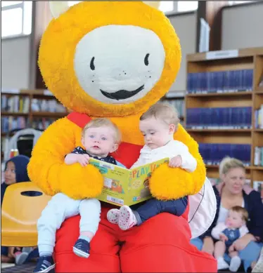  ??  ?? Farah Miller, aged 11 months and Marcus Miller, aged 10 months, settle down for a story with Bookbug Picture: Kirsty Anderson