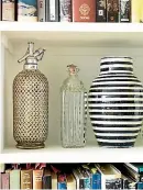  ??  ?? Barbara loves the lines on the vintage soda bottle, glass bottle and Moroccan black and white vase