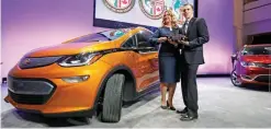  ?? — AP ?? DETROIT: General Motors Executive Chief Engineer Autonomous & Electrifie­d Vehicles and New Technology Pam Fletcher, left, and Bolt Chief Engineer Josh Tavel stand next to a Chevy Bolt after being named top car in the North America at the North American...