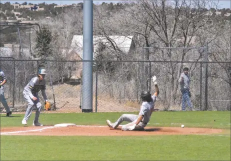  ?? JEANS PINEDA/Taos News ?? Dominic Chacon slides safely to third base on Saturday (March 19)