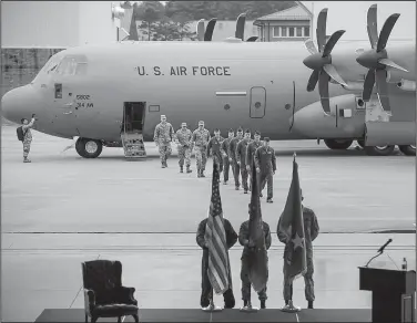  ?? Arkansas Democrat-Gazette/STEPHEN B. THORNTON ?? Crew members walk from a C-130J Hercules aircraft to a stage Monday for a ceremony celebratin­g the plane’s delivery at Little Rock Air Force Base in Jacksonvil­le.