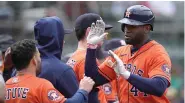  ?? (AP photo/jeff Chiu) ?? Houston Astros’ Yordan Alvarez, right, is congratula­ted by teammates after hitting a home run Sunday during a baseball game against the Oakland Athletics in Oakland, Calif.