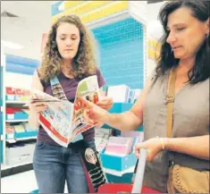  ?? — Photo by The Associated Press ?? Abbie Belcher, 17, a student at the Internatio­nal Christian School Budapest, Hungary, shops with her mother, Kathy Belcher, Aug. 6 in Portage, Mich.