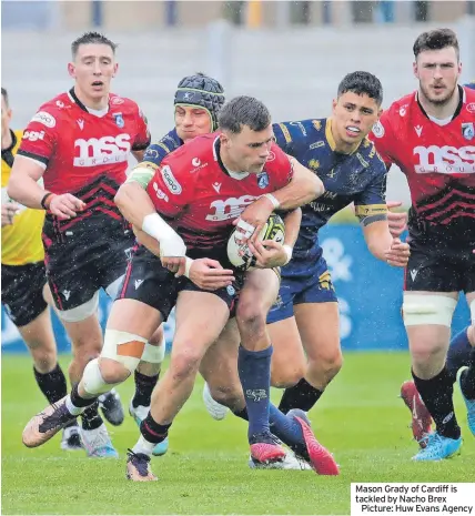  ?? ?? Mason Grady of Cardiff is tackled by Nacho Brex
Picture: Huw Evans Agency