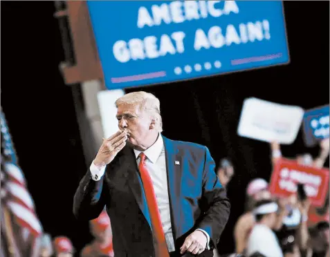  ?? BRENDAN SMIALOWSKI/GETTY-AFP ?? President Donald Trump blows a kiss to supporters after speaking Sunday during an indoor campaign rally at Xtreme Manufactur­ing in Henderson, Nevada.