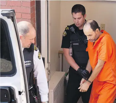  ?? ANDREW VAUGHAN / THE CANADIAN PRESS ?? Matthew Vincent Raymond, charged with four counts of first-degree murder, including the death of two police officers, is taken from provincial court in Fredericto­n on Monday. His lawyer says Raymond is likely to plead not guilty.