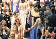  ??  ?? First cousins McKenna Paul and Montana Marshall share a low-five during the grand march. I graduated in 1998 with McKenna’s mom Angie.