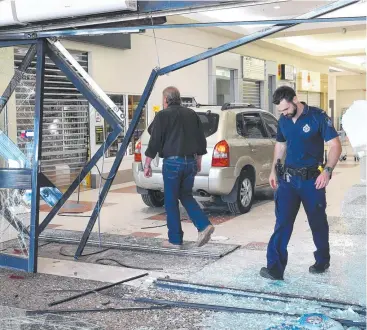  ?? Pictures: ANNA ROGERS ?? CO-ORDINATED ATTACK: Police inspect the damage at Redlynch Central.