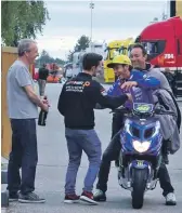  ??  ?? Multiple Moto GP World Champion Valentino Rossi stops by to congratula­te John on his first ever World Champion race win in Brno, Czech Republic, in 2016.