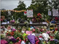  ?? CARL COURT — GETTY IMAGES ?? Flowers and tributes are placed around the wall of the Botanic Gardens in Christchur­ch, New Zealand.