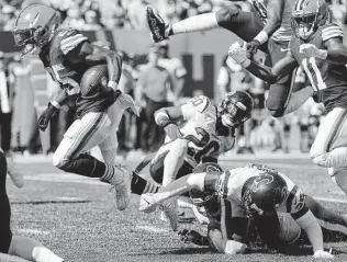  ??  ?? Browns running back Demetric Felton runs through the Texans defense on a 33-yard reception for a touchdown during the second half on Sunday at FirstEnerg­y Stadium in Cleveland.