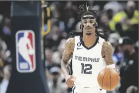  ?? DAVID ZALUBOWSKI/AP ?? MEMPHIS GRIZZLIES GUARD JA MORANT (12) plays in the second half of a game on March 3 in Denver.