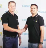  ??  ?? Walmart CEO Carl Douglas McMillon with Flipkart co-founder and group CEO Binny Bansal