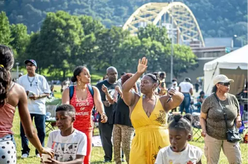  ?? Alexandra Wimley/Post-Gazette ?? Visitors join in with a choreograp­hed line dance led by Roland Ford at the 2021 Pittsburgh-Allegheny County Juneteenth Freedom Days Celebratio­n in Point State Park, Downtown.