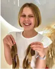 ?? ?? Aurelia Reeves with the hair she donated to a UK charity