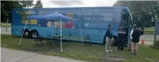  ?? BOSTON HERALD FILE ?? SHOT STOP: Crew from the state’s vaccinatio­n bus await patients earlier this month at Carson Beach in Southie.