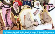  ??  ?? His Highness the Amir Sheikh Sabah Al-Ahmad Al-Jaber Al-Sabah signs a book as His Highness the Crown Prince Sheikh Nawaf Al-Ahmad AlJaber Al-Sabah looks on.