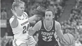  ?? ?? Wisconsin senior guard Natalie Leuzinger, guarding Iowa star guard Caitlin Clark during a game in December, has gone from a walk-on to valuable member of the Badgers. She has started 23 of 26 games this year and is fifth on the team in minutes played.