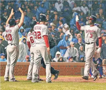  ?? DENNIS WIERZBICKI, USA TODAY SPORTS ?? The Nationals congratula­te Michael Taylor (3) after his grand slam capped the crucial win.