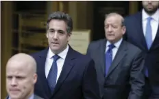  ??  ?? In this May 30 file photo, attorney Michael Cohen, second from left, leaves court in New York. President Donald Trump is distancing himself from Cohen, who is facing an FBI investigat­ion of his business dealings. AP PHOTO/SETH WENIG