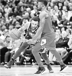  ??  ?? Stephen Curry of the Golden State Warriors tries to move against David Nwaba of the Chicago Bulls at the United Center on in Chicago, Illinois. — AFP photo