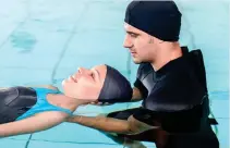  ??  ?? SOOTHING:
A therapist gently guides a client around the pool