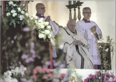  ?? AP PHOTO/ALESSANDRA TARANTINO ?? Pope Francis sits on the altar during the Catholic Easter Sunday mass in St. Peter’s Square at the Vatican, on Sunday.