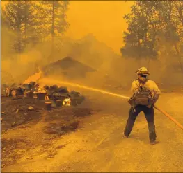  ?? INCIWEB — CONTRIBUTE­D ?? A Cal Fire crew provides structure defense in Junction City. The Monument Fire, as of Tuesday, is 119,280 acres with 10% containmen­t.