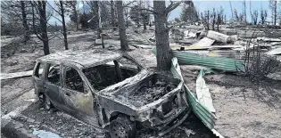  ??  ?? Scorched earth . . . More than 40 houses were destroyed by the blaze in Ohau Village.