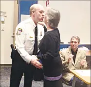  ?? Jeff Mill / Hearst Connecticu­t Media ?? Dennis Woessner kisses his wife, Sherrill, after she pinned on his badge as the new police chief of the East Hampton Police Department on Tuesday.