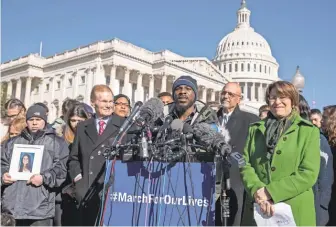  ?? J. SCOTT APPLEWHITE/ AP ?? Robert Edwards, center, a student from Washington, rallies with lawmakers and supporters on the eve of Saturday’s march in the capital.