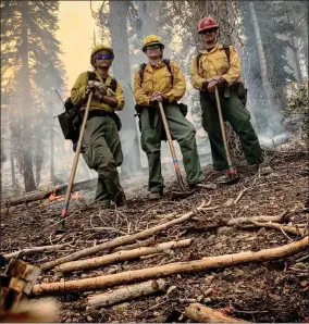  ?? CONTRIBUTE­D PHOTO ?? Fire personnel take a moment to pose for a photo as they work to contain the SQF Comlplex fires on Wednesday.