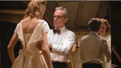  ?? Focus Features ?? Vicky Krieps, left, portrays an unrefined waitress who becomes model and muse for a narcissist­ic dressmaker played by Daniel DayLewis in “Phantom Thread.”