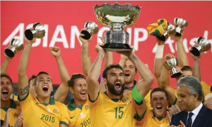  ?? Photograph: Mark Kolbe/Getty Images ?? Mile Jedinak and his team celebrate as he lifts the trophy after victory during the 2015 AsianCup final match between Korea Republic and the Socceroos.