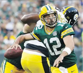  ?? JEFFREY PHELPS/THE ASSOCIATED PRESS/FILES ?? Packers quarterbac­k Aaron Rodgers’ new US$134-million contract extension will keep him in Green Bay until 2023.