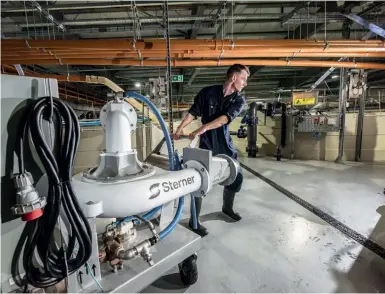  ??  ?? Above: Hatchery technician Rhuairaidh MacDonald moving one of the Sterner pumps. Opposite (top): Faivre drum filters. (Below): Recently emptied smolt tanks