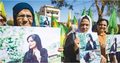  ?? Picture: AFP ?? SOLIDARITY. Syrian Kurdish women in a demonstrat­ion in Hasakeh city on Sunday to express their support for 22-year-old Mahsa Amini, in pictures, who died while in the custody of Iranian authoritie­s.