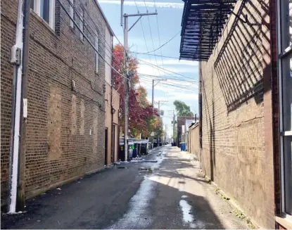  ?? SAM CHARLES/SUN-TIMES ?? A 7-year-old girl was shot while trick-or-treating Thursday in this alley in the 3700 block of West 26th Street.