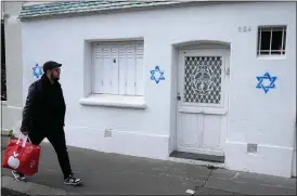  ?? MICHEL EULER - THE ASSOCIATED PRESS ?? Spray-painted stars of David on a wall on Oct. 31in Paris.