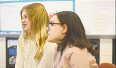  ?? H John Voorhees III / Hearst Connecticu­t Media ?? Alexandra Bender, left, and Hannah Stowell, students at Bethel Middle School, started a club at the school to work on empowering girls around the world. The Girl Up club is an offshoot of a United Nations campaign that aims to give young woman the resources to fight for gender equality. Teacher Caitlin Boles is the club adviser.