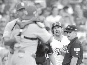  ?? Wally Skalij Los Angeles Times ?? ADRIAN GONZALEZ is held back as he argues with Cardinals catcher Yadier Molina in playoff opener. Zack Greinke, who has had success against the Cardinals, will pitch for the Dodgers today.