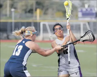  ?? Nikolas Samuels/The Signal ?? (Above) Valencia’s Kianna Shakir (12) winds up to shoot a ball that scored a goal against Crescenta Valley at Valencia on Friday. (Below) Valencia’s Katarina von Mecklenbur­g (18) works the field during game.