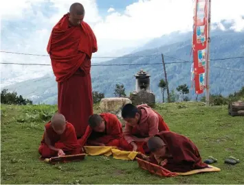  ??  ?? RIGHT: Students study and recite sacred Buddhist texts at the Phajoding Monastery in the mountains above Thimphu. BELOW: One of the camp cooks makes delectable “momos” on the second-last day of the trek. Momos are a South Asian-style steamed dumpling...